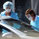 Medical personnel take a sample from a person at a drive-thru covid-19 testing station at a Kaiser Permanente facility on March 12, 2020 in San Francisco, California